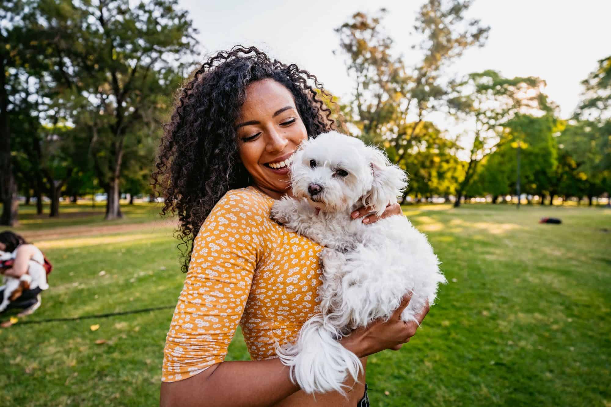 Woman and dog at park.